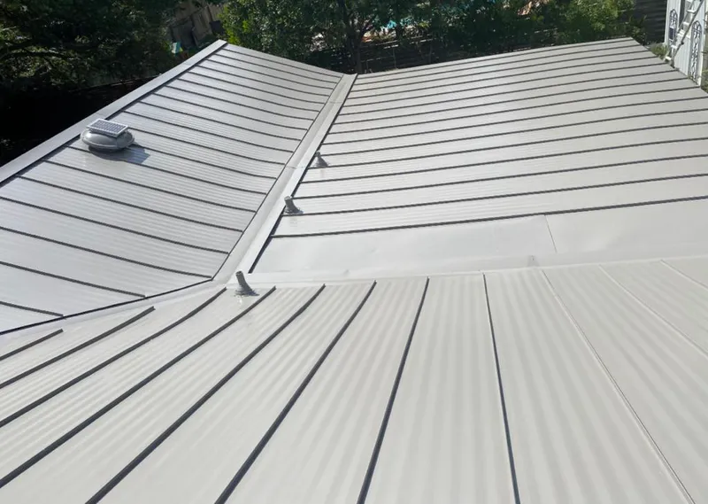 Solar attic fan installed on a metal roof for Roof Ventilation in Valley Park